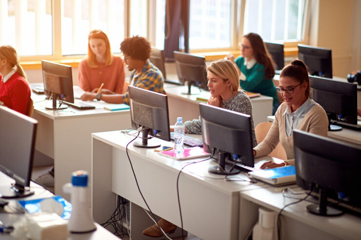 IT workshop at university. Group of Students on class with compu Formation